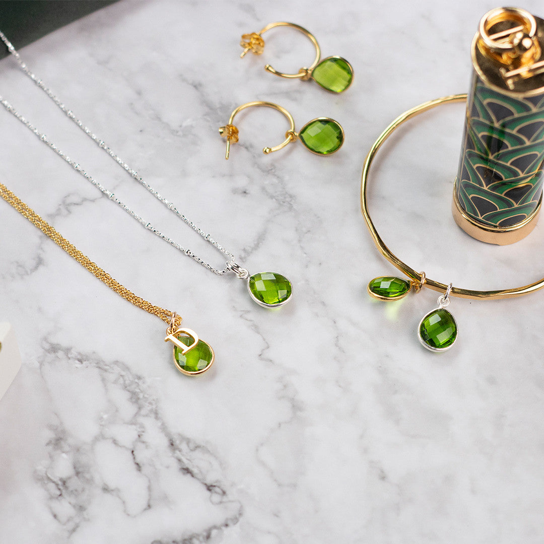 collection of jewellery with peridot birthstones attached