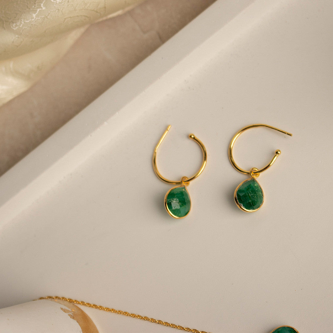 emerald drop hoop earrings in gold