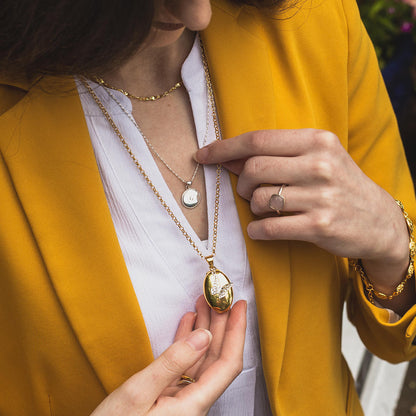 Limited Edition King Charles III Coronation  Necklace featuring the Commemorative Hallmark on a model wearing a yellow jacket