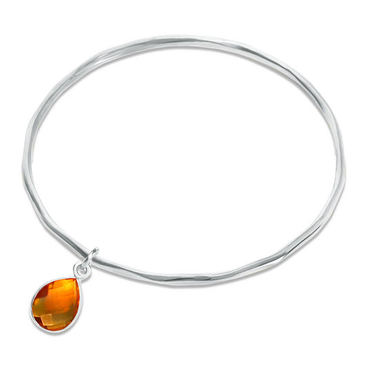 Citrine charm bangle in silver on a white background