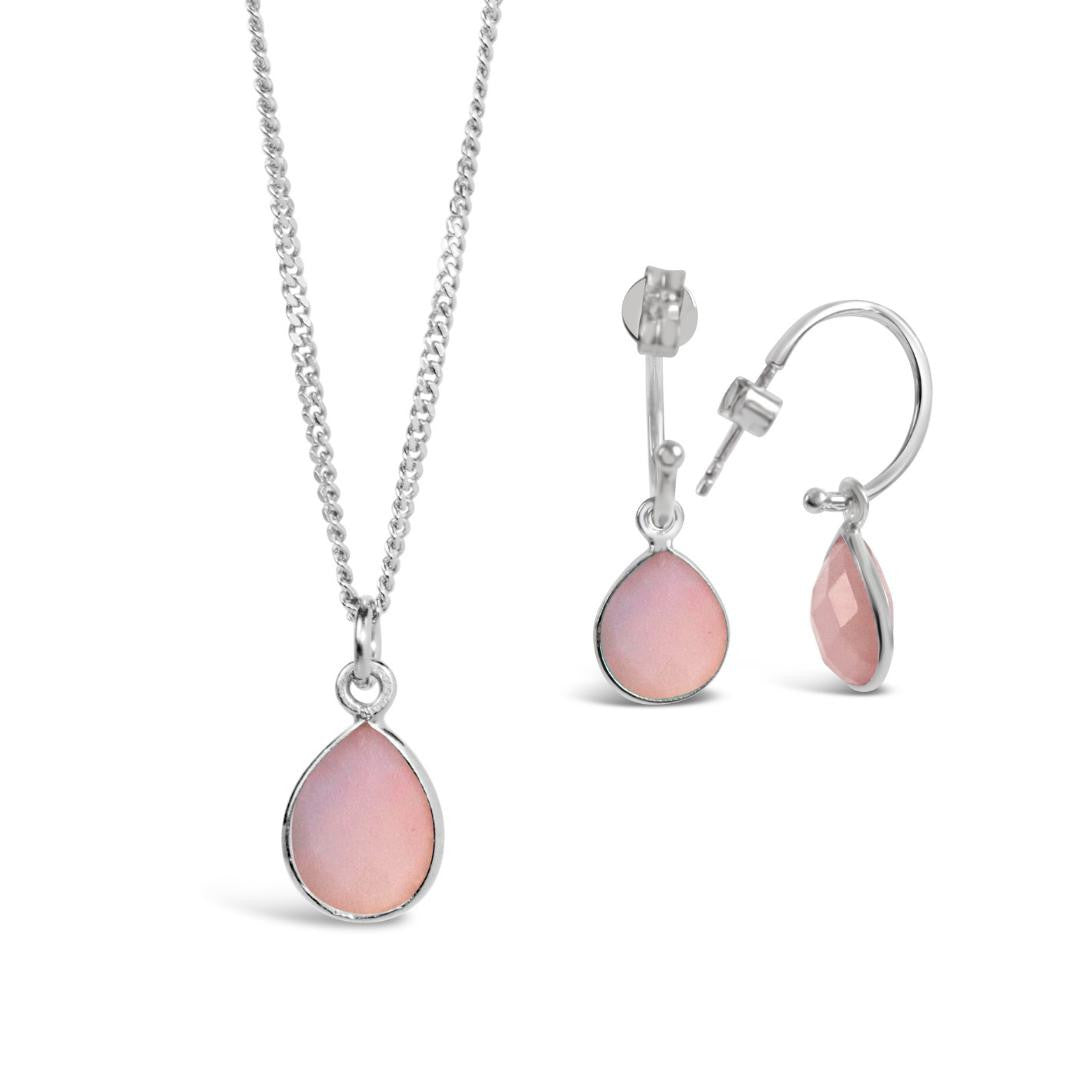 pink opal charm necklace and drop hoop earrings in silver on a white background