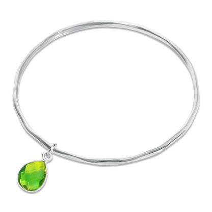 peridot charm bangle in silver on a white background
