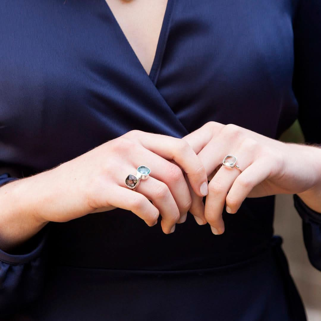 close up of model wearing three cocktail rings in silver