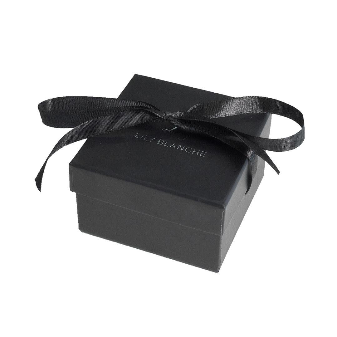 black ribbon-tied gift box on a white background