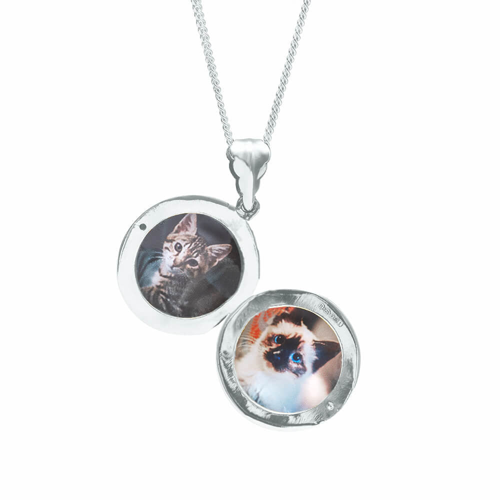 round locket necklace in silver on a white background