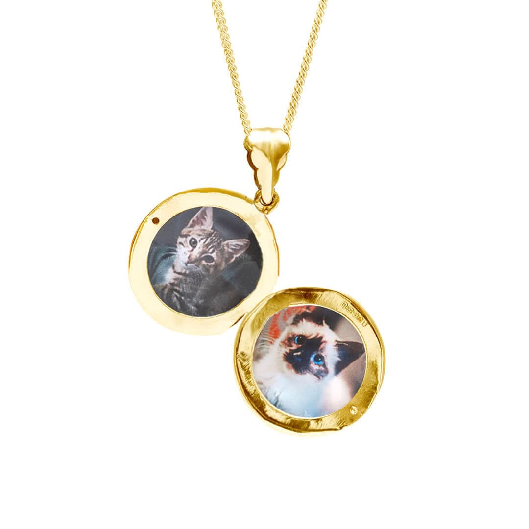 round locket necklace in gold with photos inside on a white background