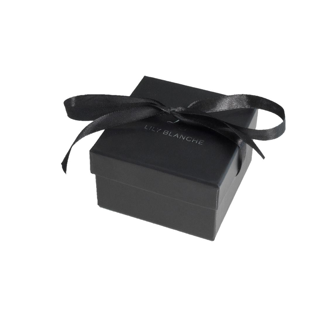 black ribbon-tied lily blanche gift box on a white backround