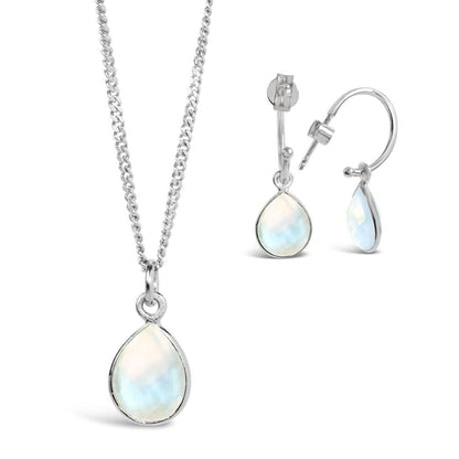 moonstone drop hoop earrings and necklace in silver on a white background