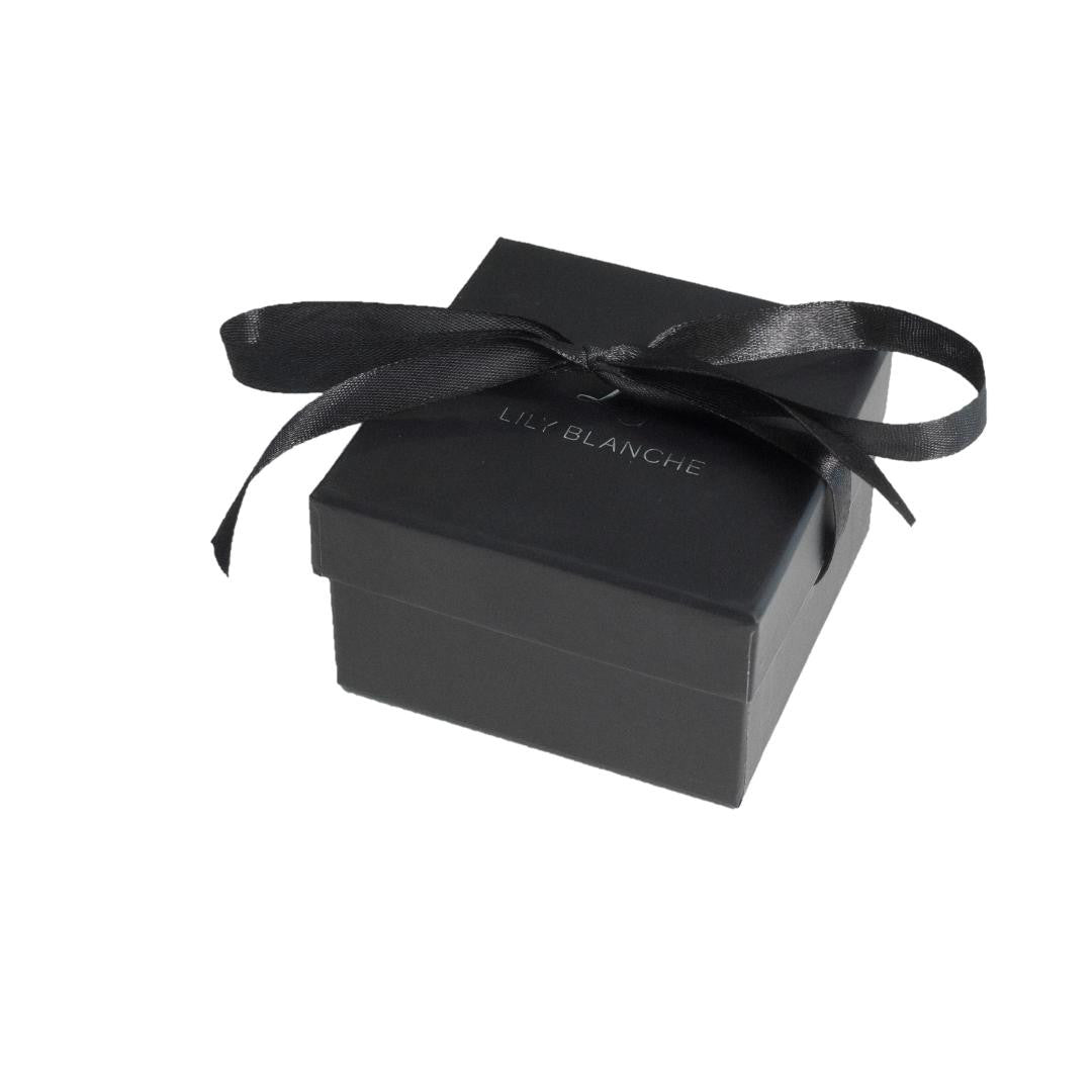 black ribbon-tied lily blanche gift box on a white background