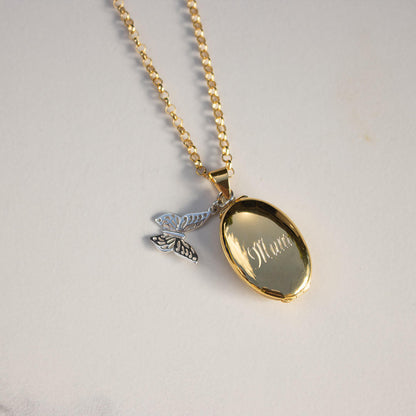 Lily Blanche gold oval shaped locket with butterfly charm and engraved message