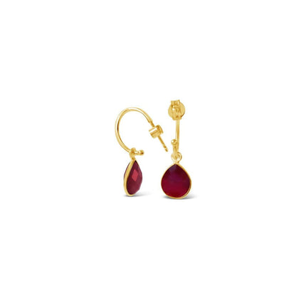 garnet drop hoop earrings in gold on a white background