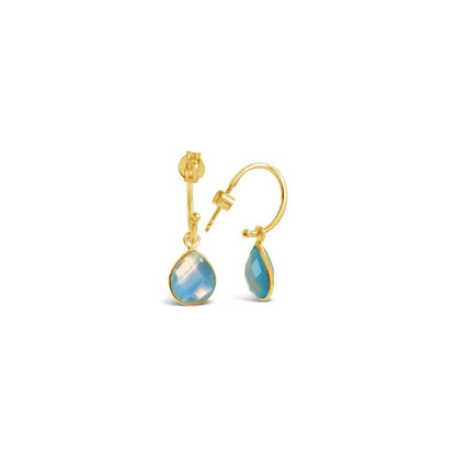 blue topaz drop hoop earrings in gold on a white background