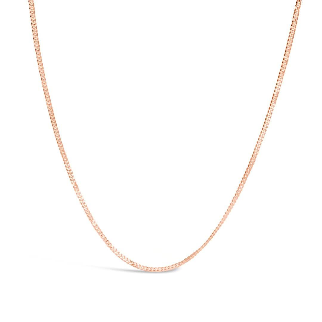 rose gold curb chain on a white background