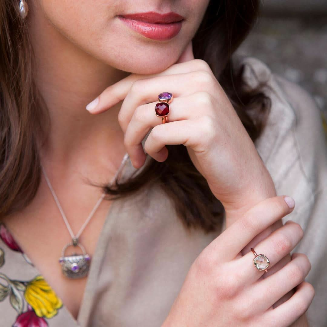 closeup of model wearing amethyst handbag locket in silver