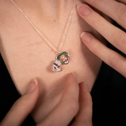female model wearing a heart shaped locket in silver