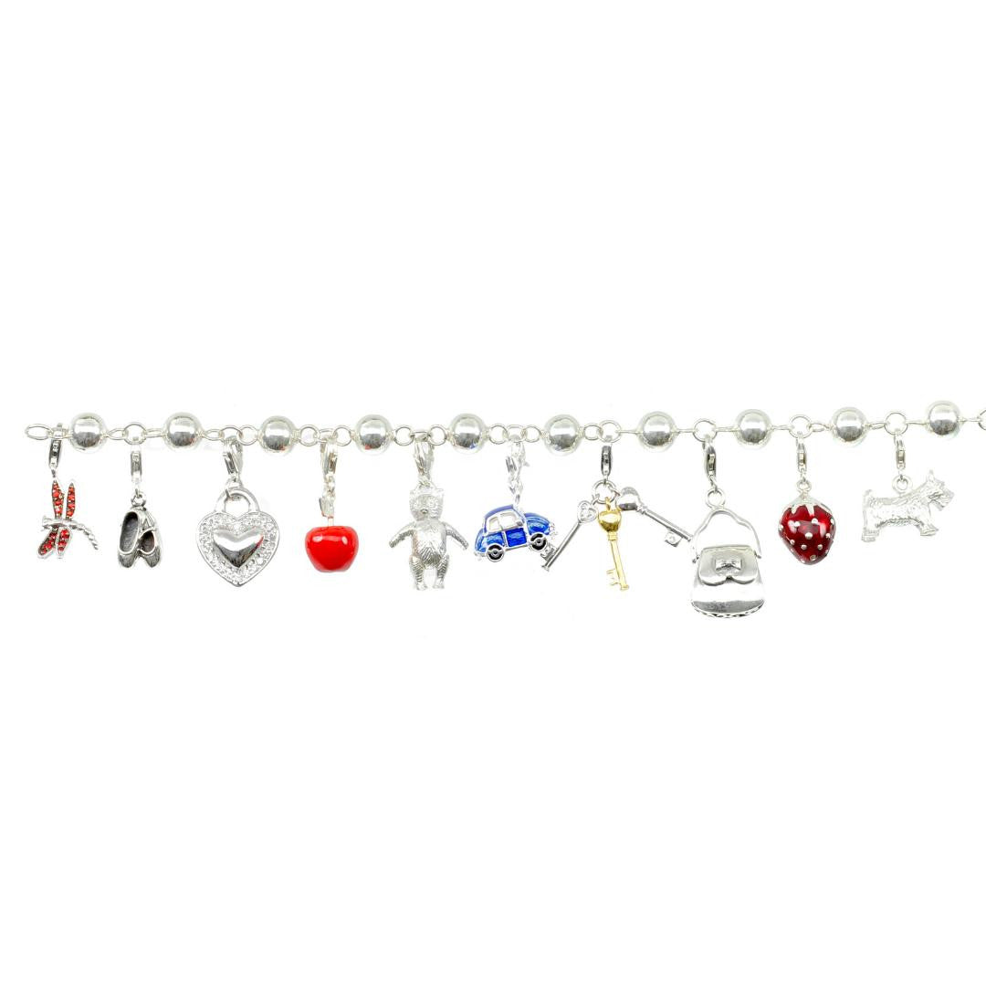 charm bracelet with beetle car charm attached on a white background