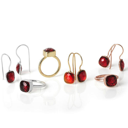 collection of garnet jewellery on a white background