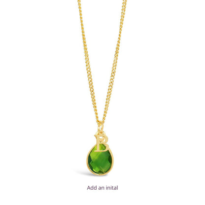 peridot charm necklace in gold with the initial  B attached on a white background