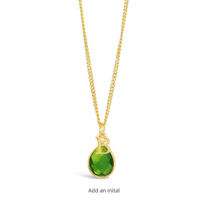 peridot charm necklace in gold with the initial  B attached on a white background