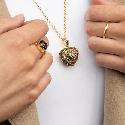 women modelling sapphire vintage heart locket in gold