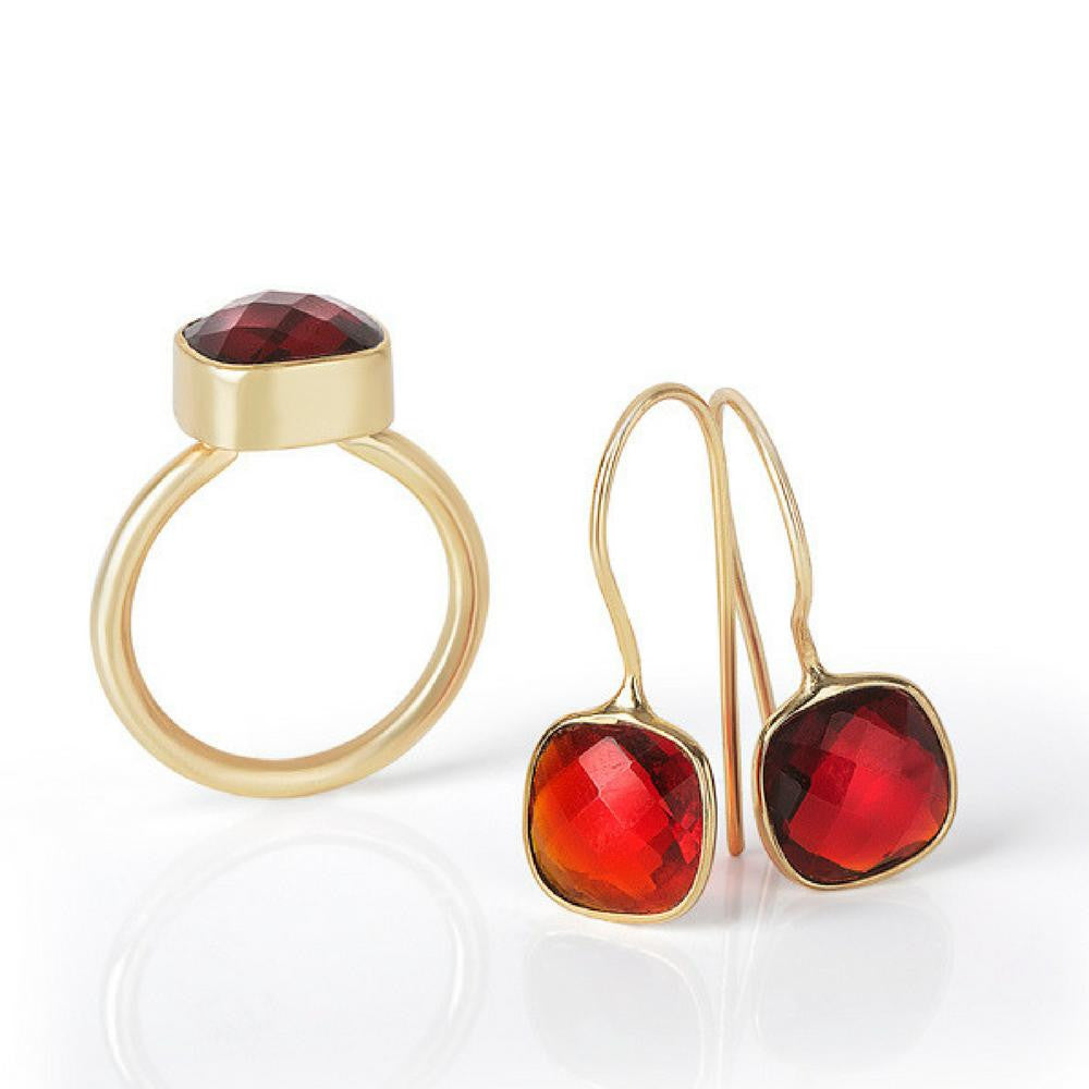 garnet earrings in gold and cocktail ring on a white background