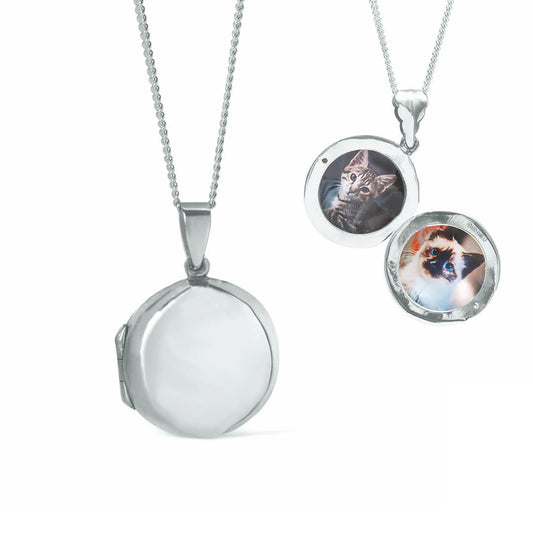 round locket necklace in silver with photos inside on a white background