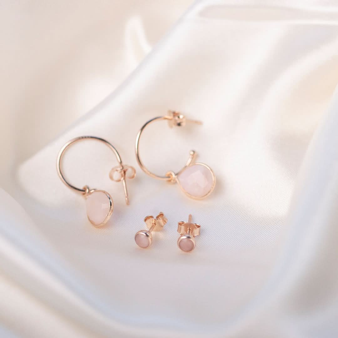 pink opal mini stud earrings with matching hoop earrings in rose gold on a white piece of fabric