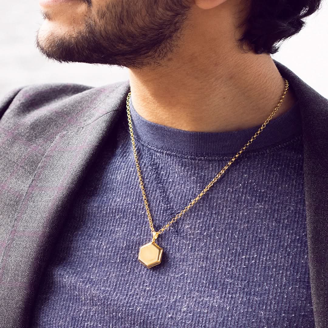 model wearing hexagon locket in gold