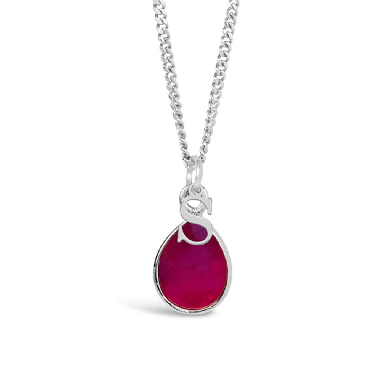 ruby charm necklace in silver with initial charm on a white background