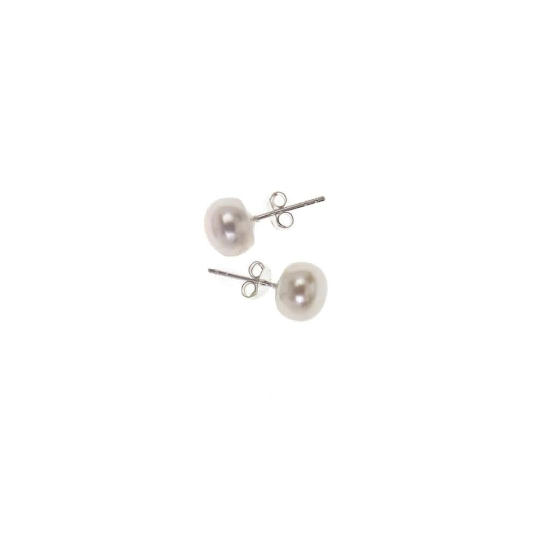 classic pearl earrings in ivory on a white background