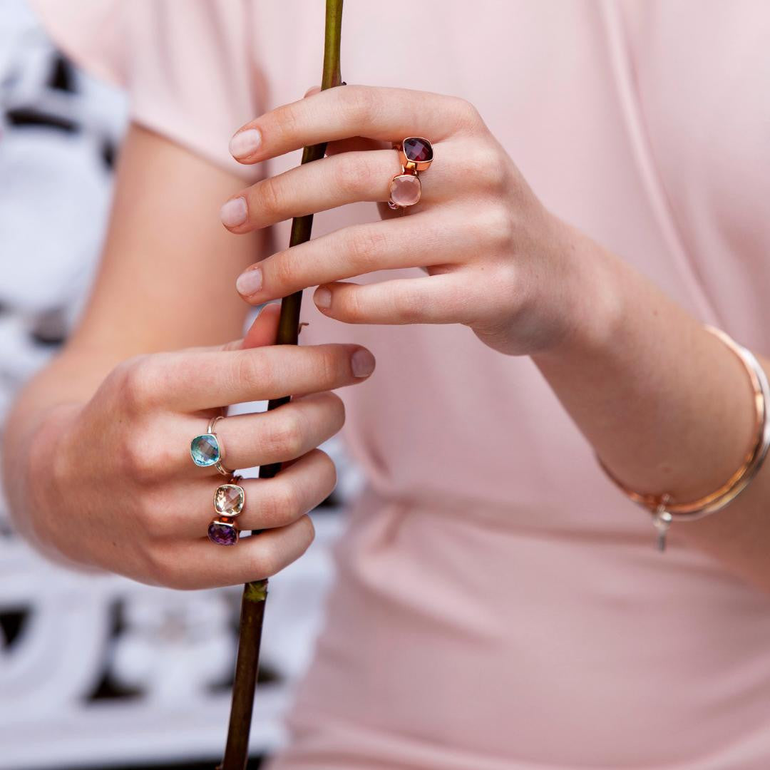 model wearing six cocktail rings in gold 