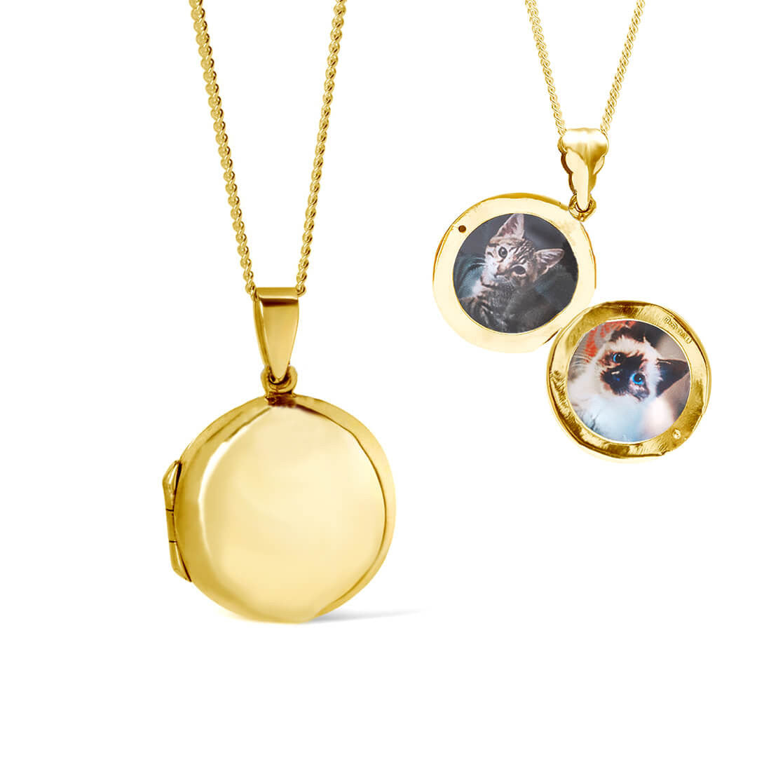 round locket necklace in gold with photos inside on a white background