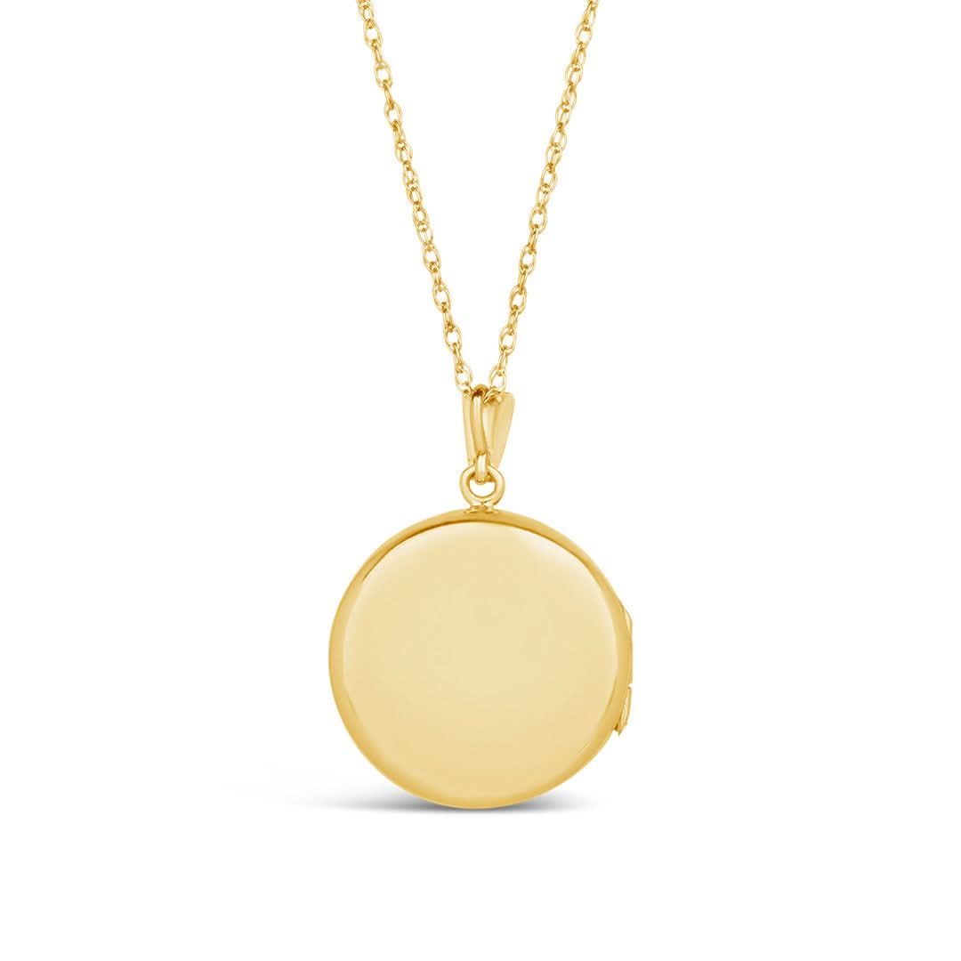 back of gold round diamond locket on white background