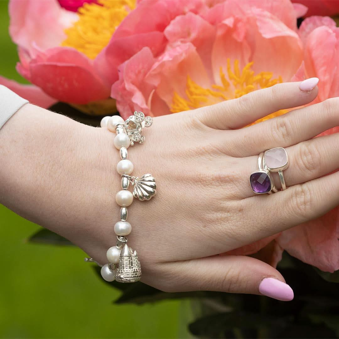 model wearing bracelet with magical charms attached