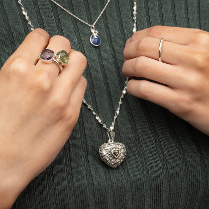 women modelling sapphire vintage heart locket in white gold with sapphire necklace