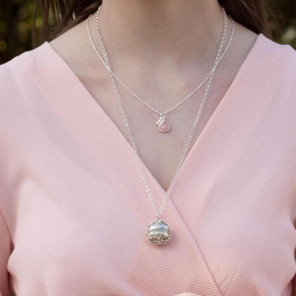 model in pink top wearing white gold memory keeper locket