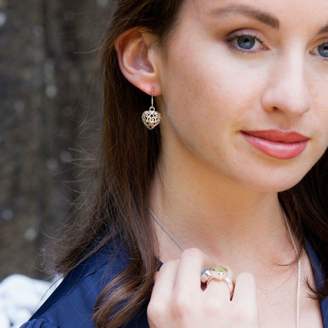 model wearing heart earrings in silver 