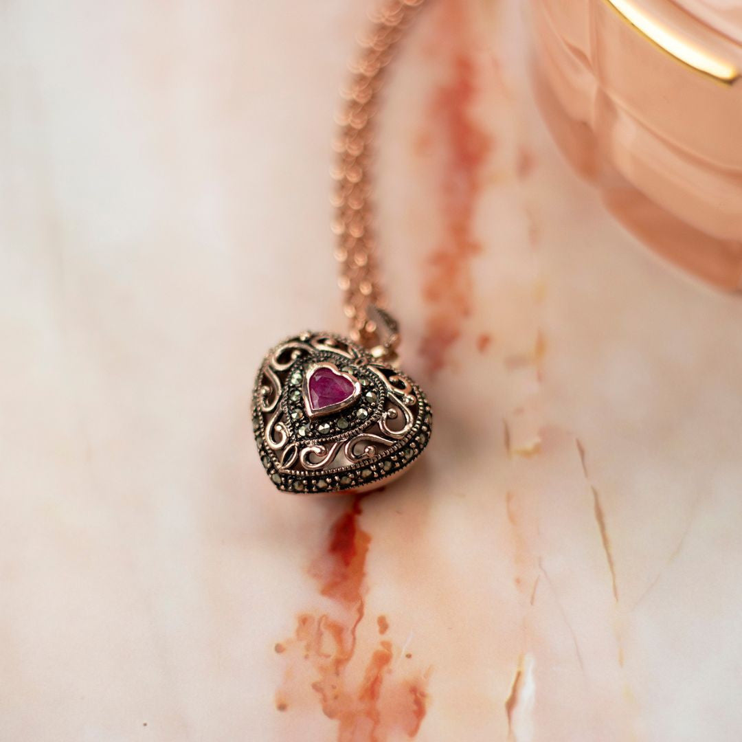 closeup of rose gold ruby vintage locket necklace
