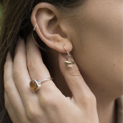 model wearing bird earrings in gold