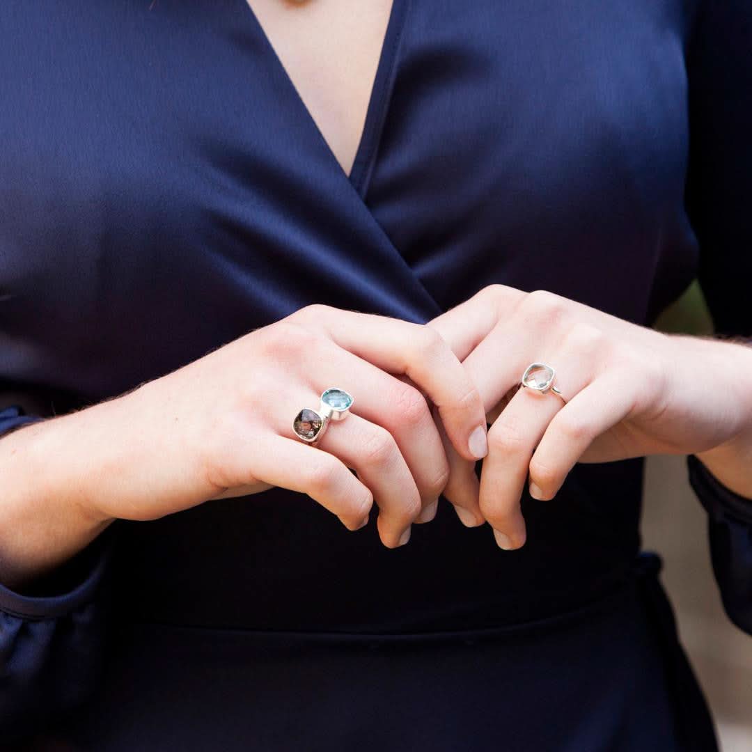 model wearing three cocktail rings in silver with different gemstones
