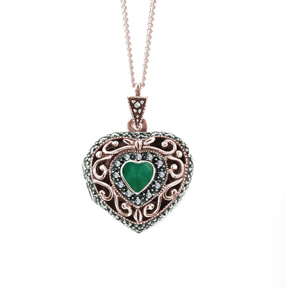 emerald vintage heart locket in rose gold on a white background