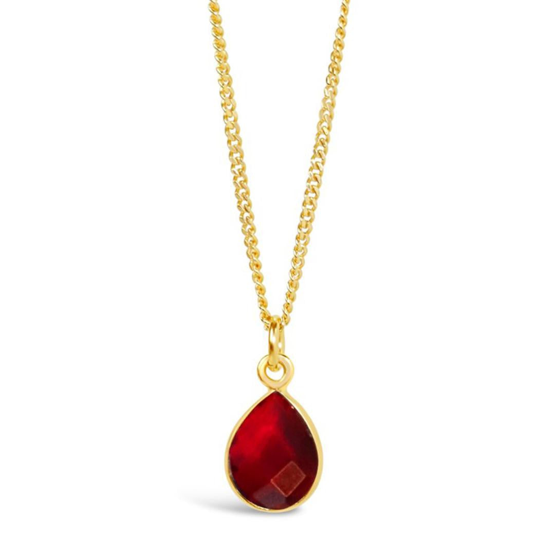 garnet charm necklace in gold on a white background