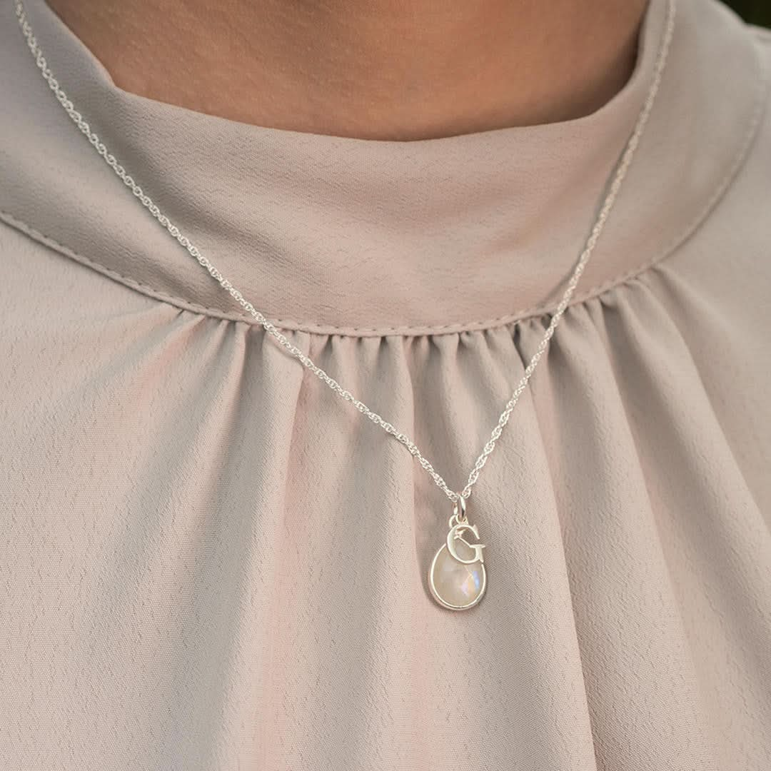 model wearing silver rope chain with silver birthstone and intitial