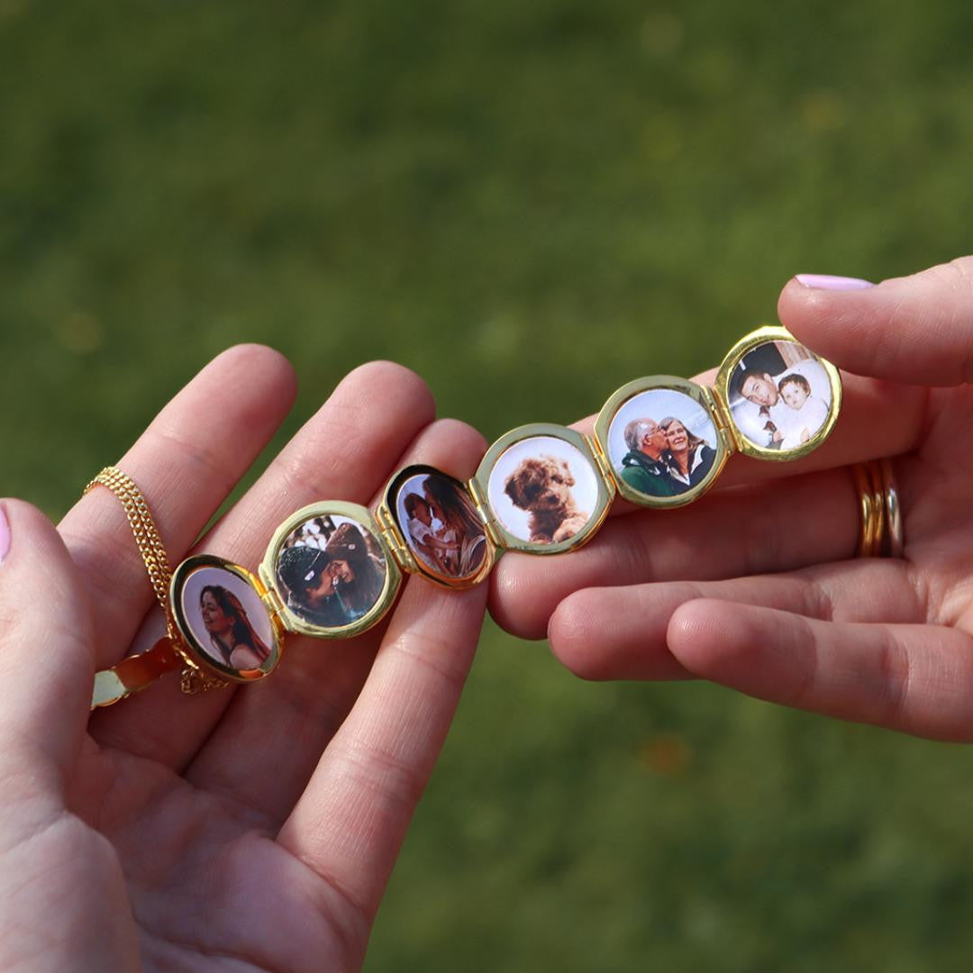 person holding opened memory keeper locket in gold