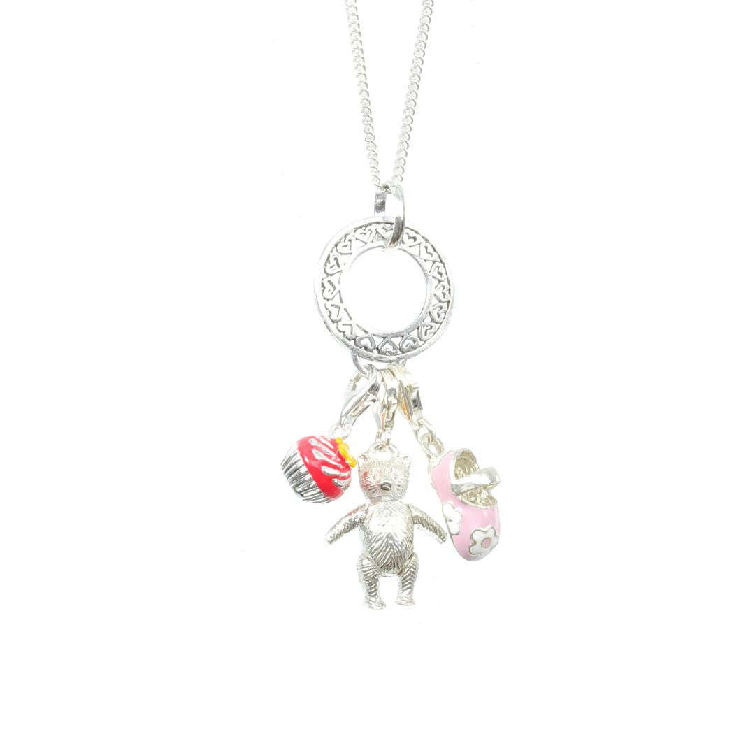 cupcake charm attached to silver charm carrier along with two other charms