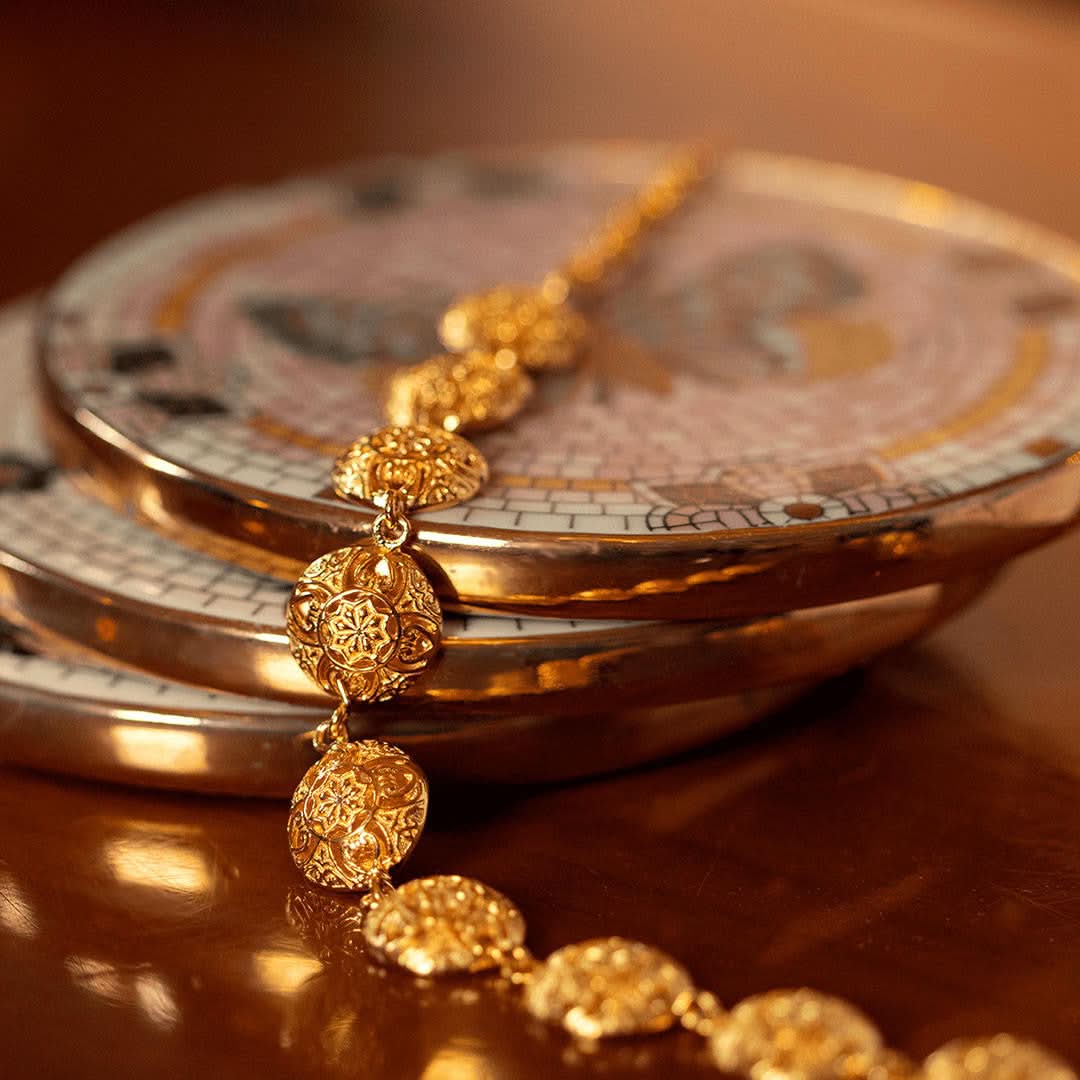 gold memory keeper bracelet on brown table