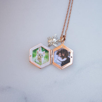 opened bee locket in rose gold with family photos inside