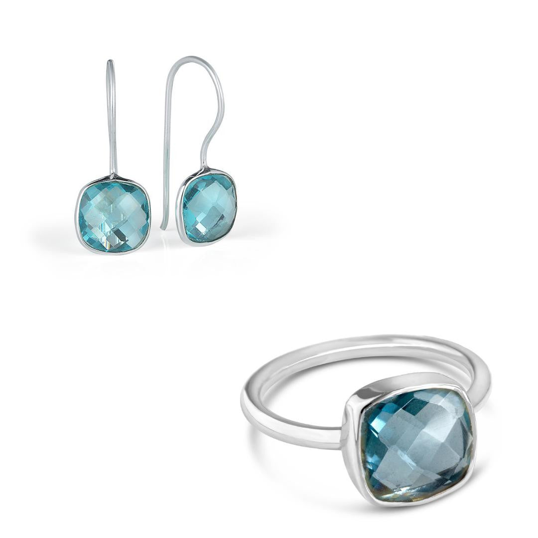 blue topaz earrings and cocktail ring in silver on a white background