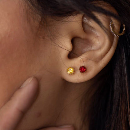 Up close model image wearing citrine mini stud earrings in rose gold