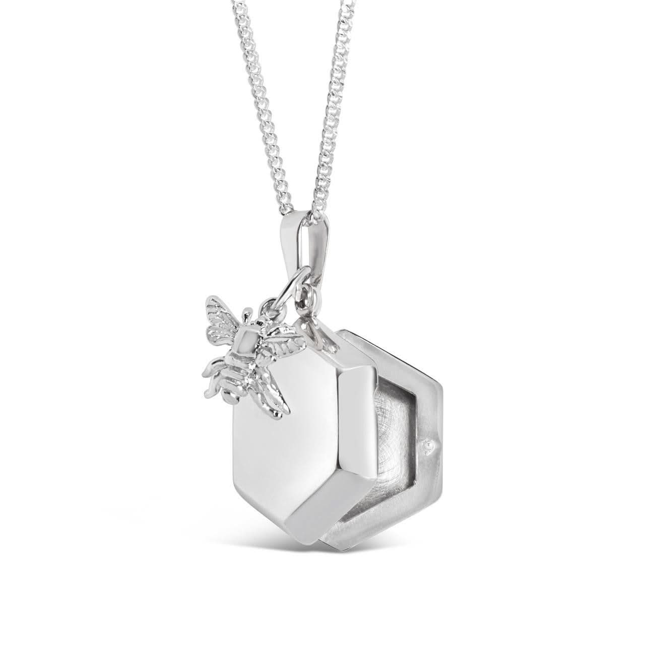 opened bee locket in silver with silver bee charm on a white background